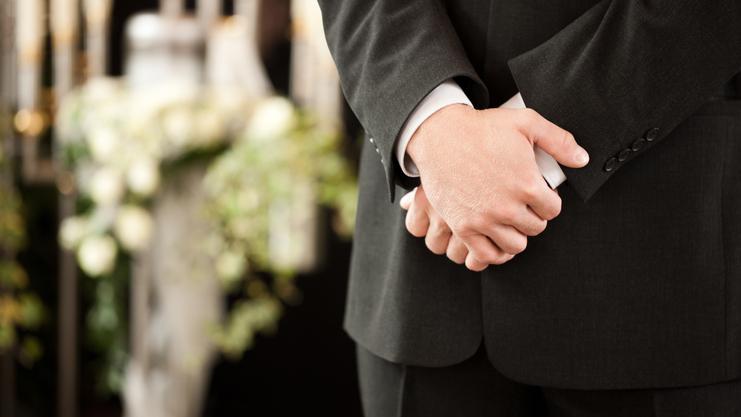 Person mit verschr&auml;nkten Armen vor Kerzen